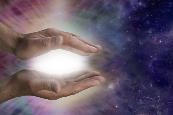 Two hands cupping an energy ball of light surrounded by a universal starscape out into which the energy ball is being sent