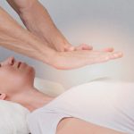 Woman receiving Healing Touch therapy from a Mind-Body Energy Medicine specialist.