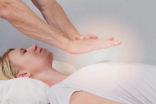 Young woman having healing touch treatment 