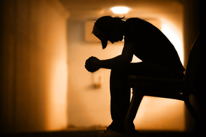 Young man with hands clasped together