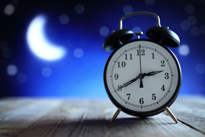 Alarm clock in the middle of the night depicting insomnia or dreaming